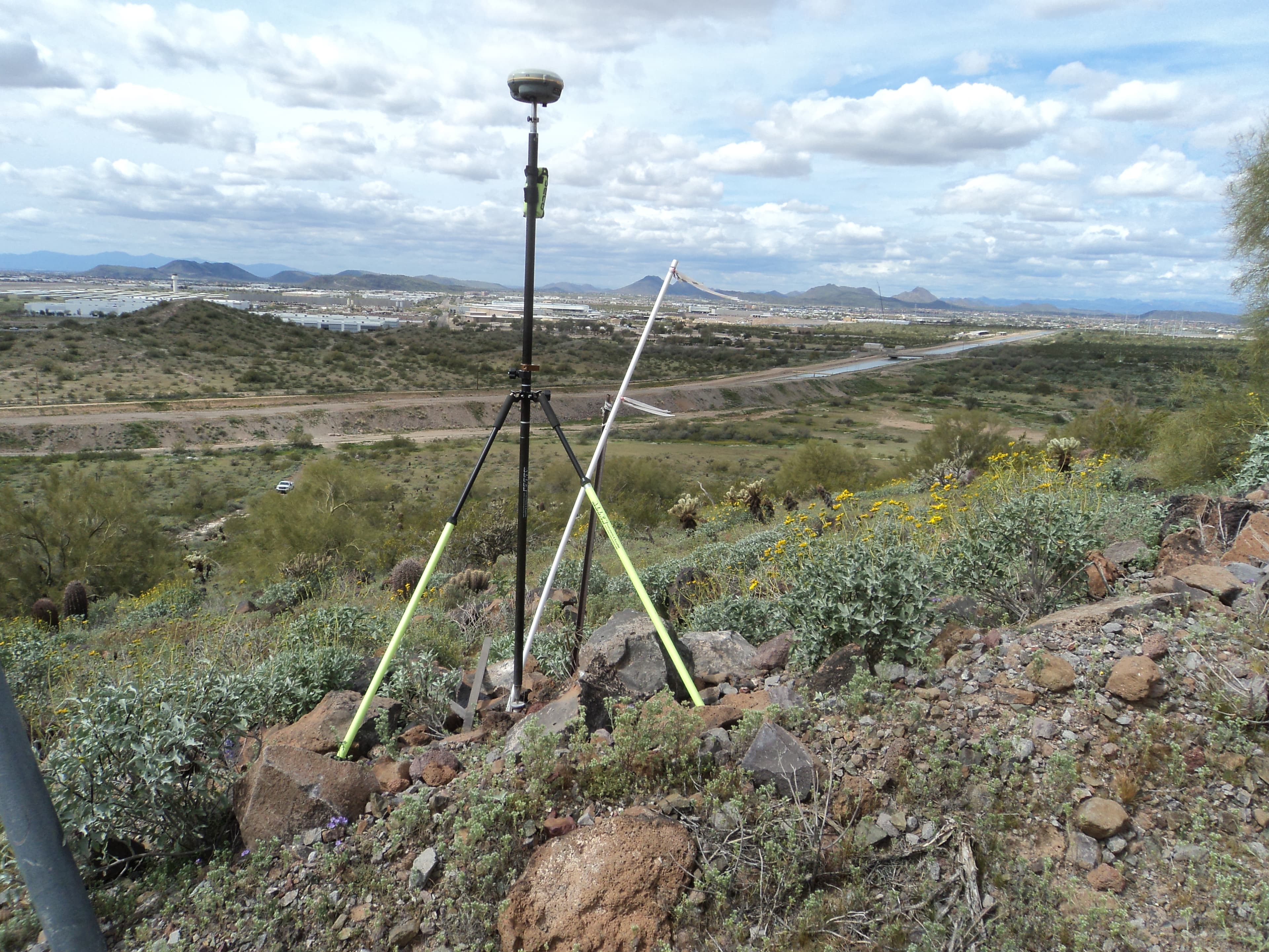 Survey equipment on hilltop overlooking the Arizona desert