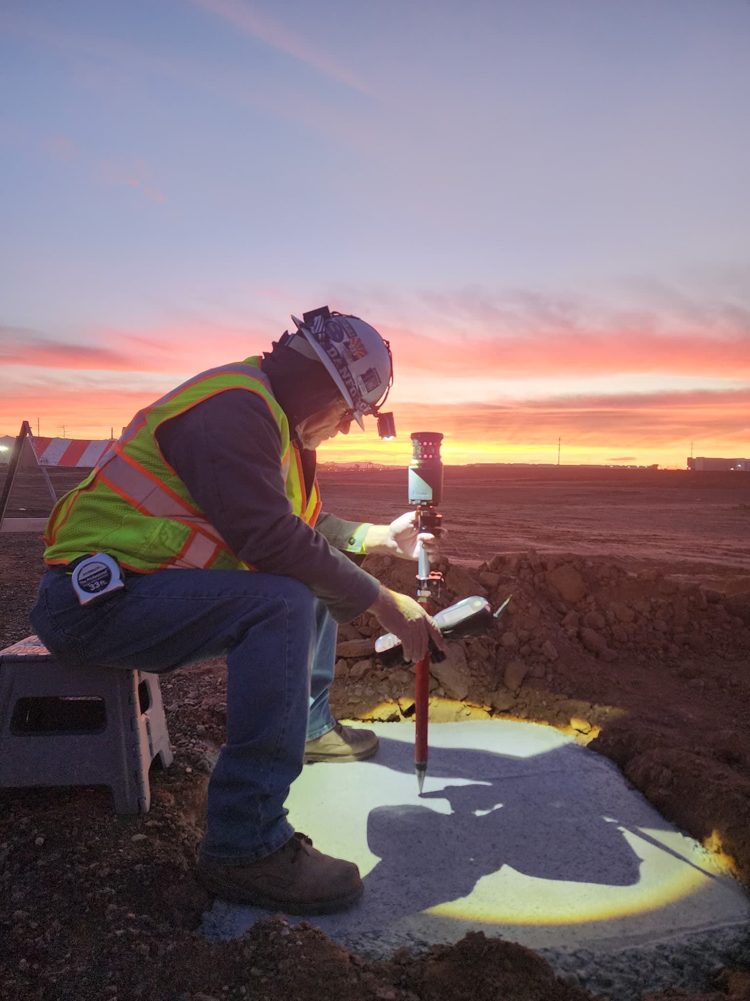 Hunter Engineering surveyor working at sunset in the Arizona desert